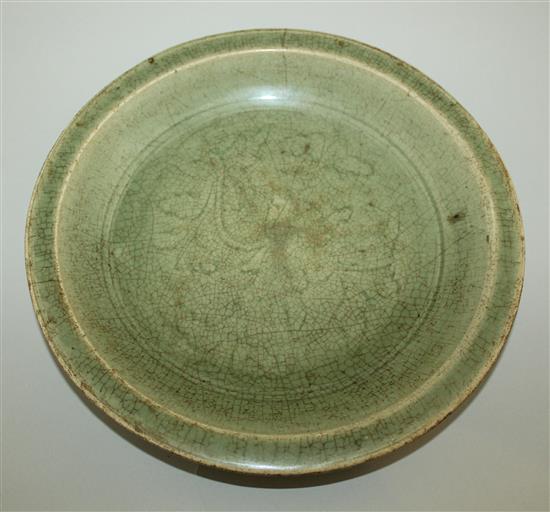 A Chinese Longquan celadon dish, 15th century, 30.5cm, rim crack and crazing to glaze